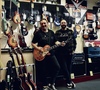 Foto von Herb und Kris im Laden mit Gitarre in der Hand